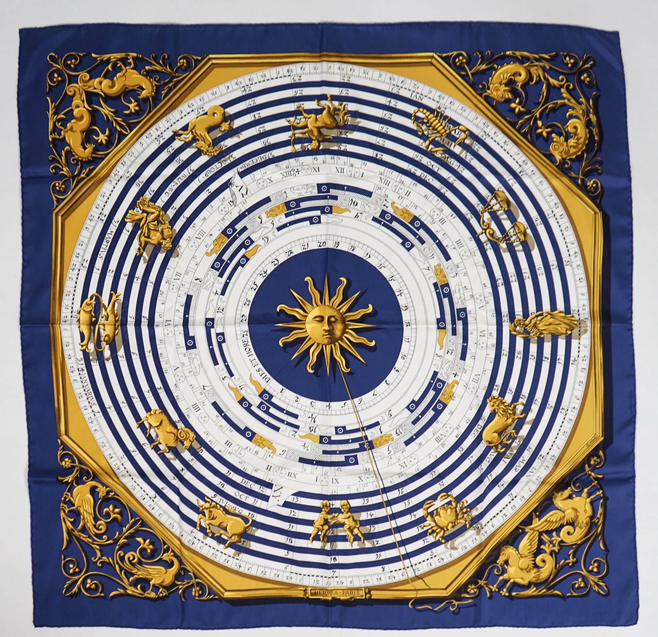 A Hermès Dies et Hore navy silk scarf, 90cm x 90cm